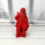 Babbo natale con pacco regalo di cera